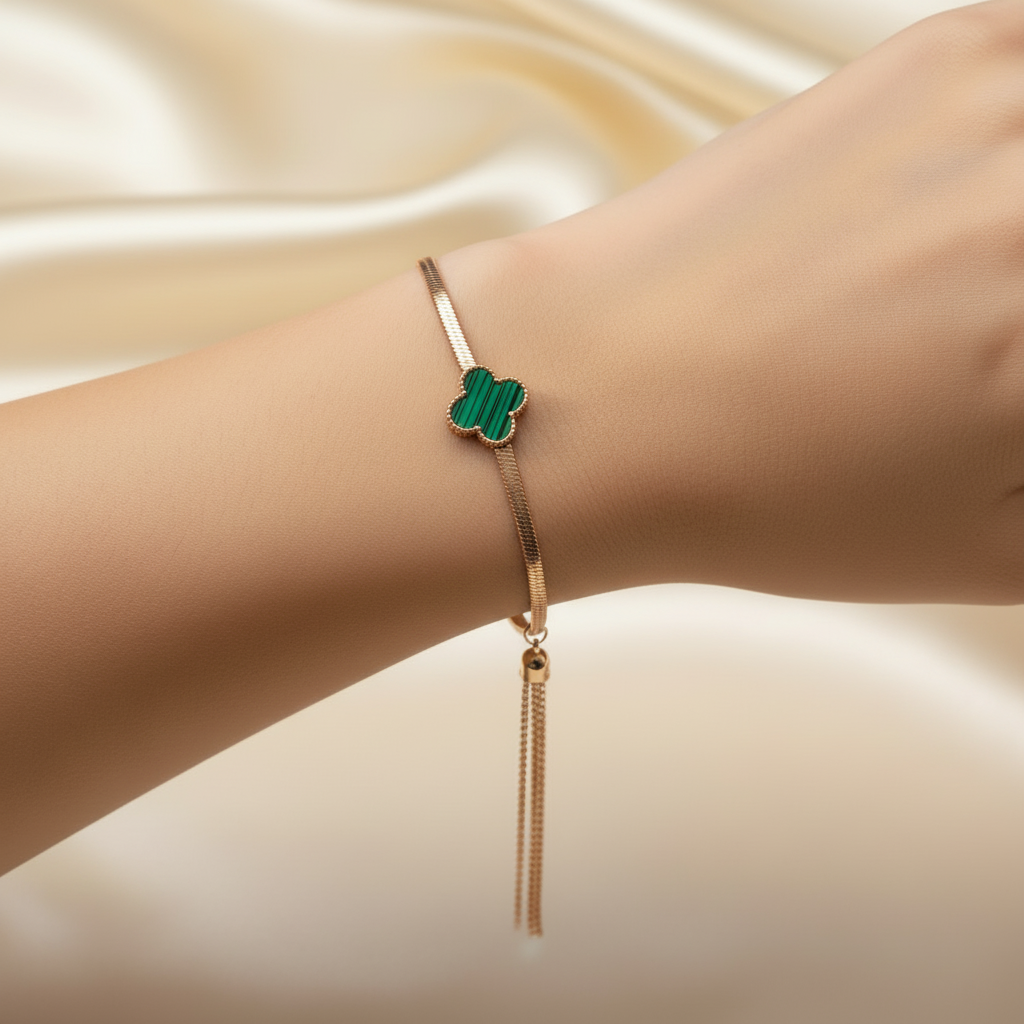 Beautiful slender wrist with rose gold green malachite quatrefoil and tassel bracelet