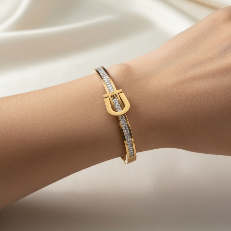 Beautiful slender wrist with belt buckle and baguette diamond bracelet
