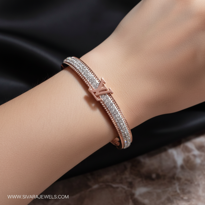 Beautiful slender wrist with rose gold designer logo and diamond bracelet