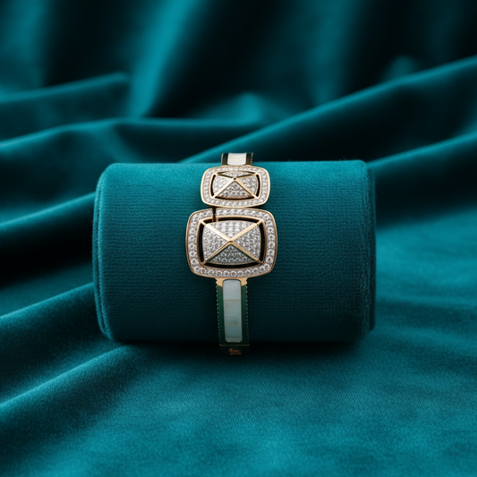 Diamond and enamel rectangular bracelet on teal cushion with teal velvet background