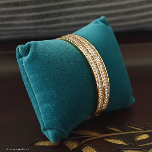 Double-row diamond bracelet with teal velvet cushion through center