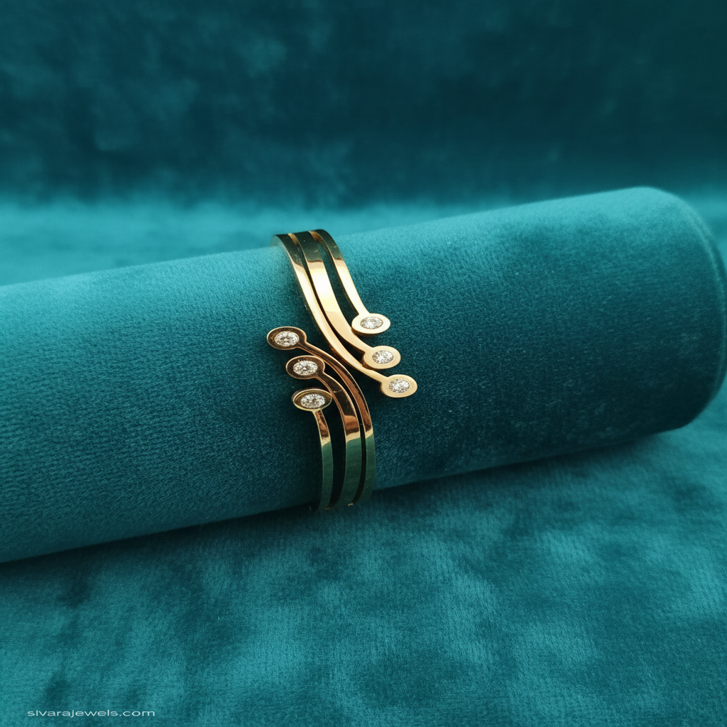 Flowing curved gold and diamond bracelet on teal jewelry cushion with teal background