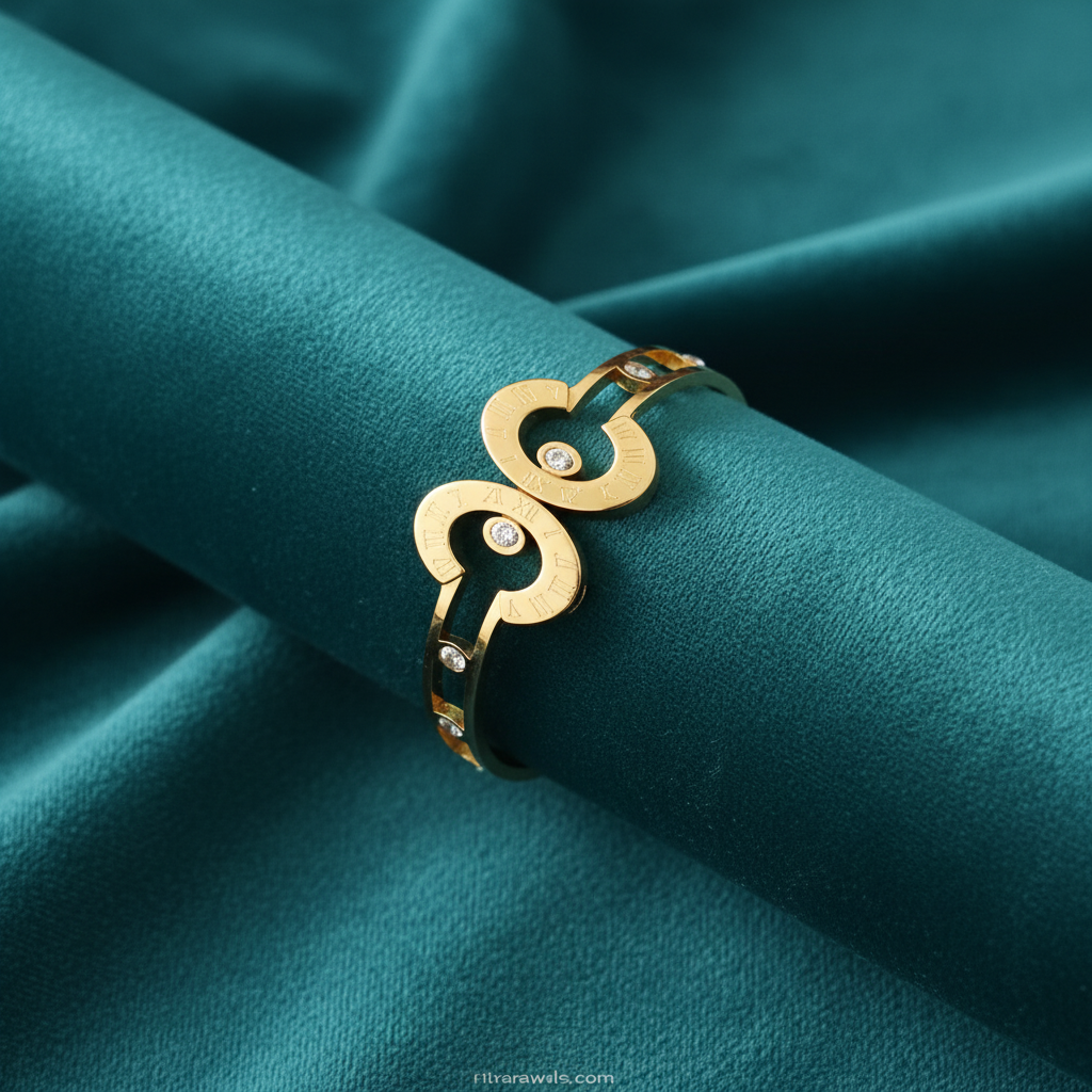 Hollow gold disc and diamond bracelet on teal jewelry cushion with teal background