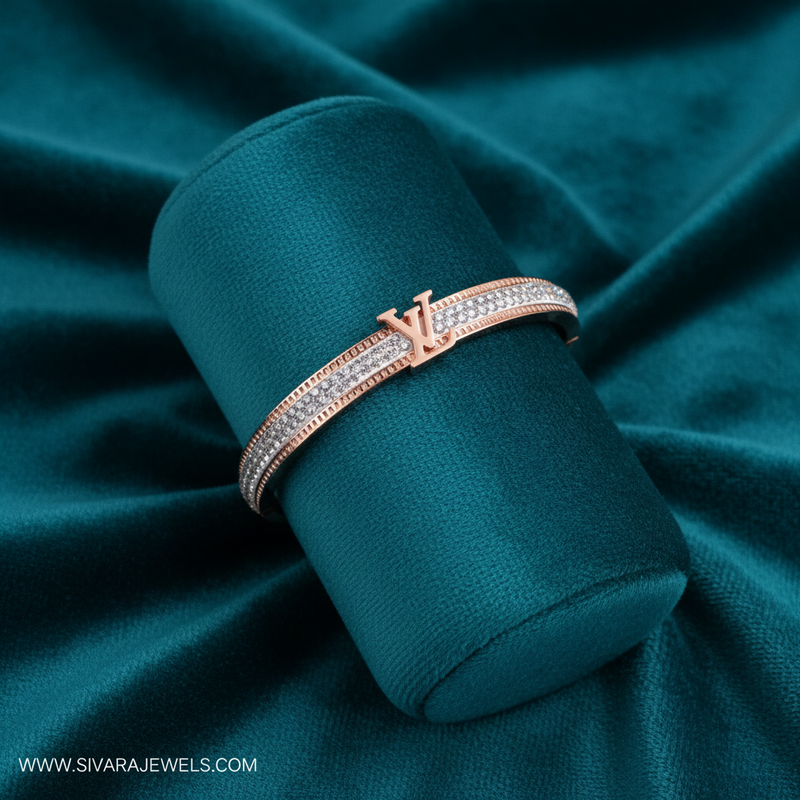 Rose gold designer logo and diamond bracelet on teal jewelry cushion with teal background