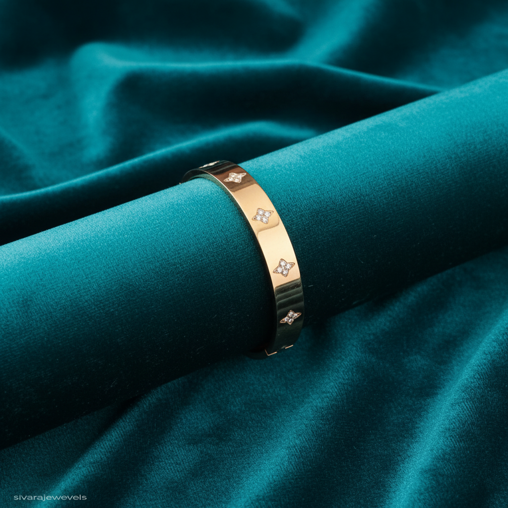 Rose gold diamond quatrefoil bangle on teal jewelry cushion with teal background
