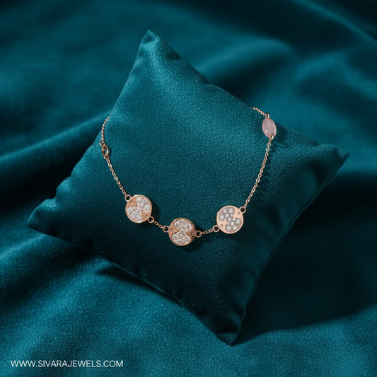 Rose gold diamond quatrefoil stations and rose quartz bracelet on slanted square teal cushion