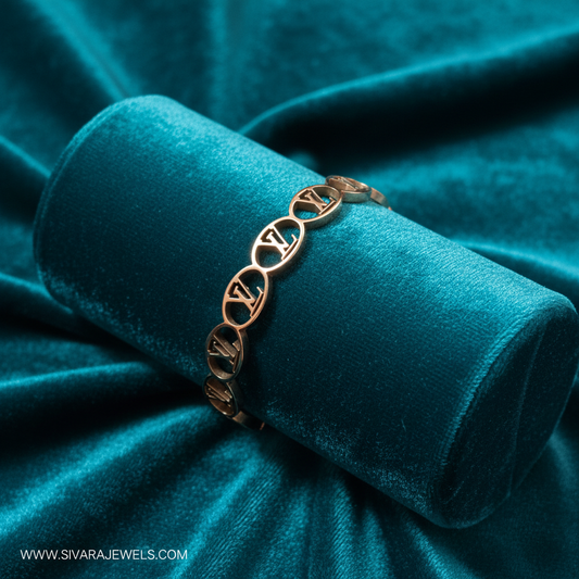 Rose gold interlocking LV chain bracelet on teal jewelry cushion with teal background